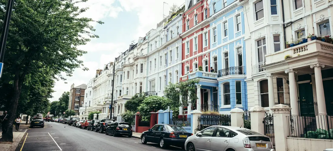 A London street of colourful stucco-fronted houses