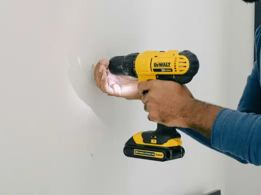 Drilling into a wall to put up a fixture