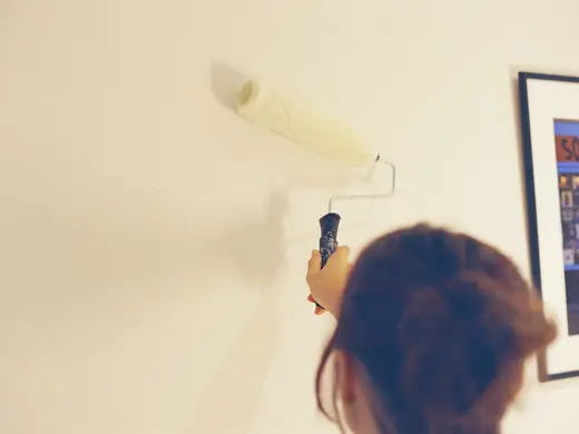 Painting a pale wall with a roller