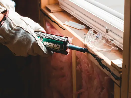 Sealing around a window frame with a sealant gun